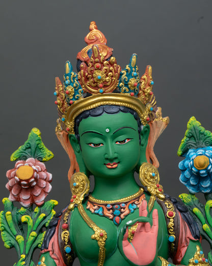 Close up view of Green Tara goddess statue showing serene expression five jewel crown gold details