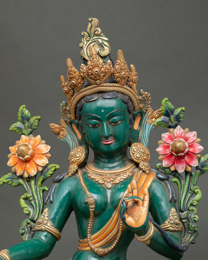 Close up view of Green Tara statue copper body with acrylic paint and gold gilding details