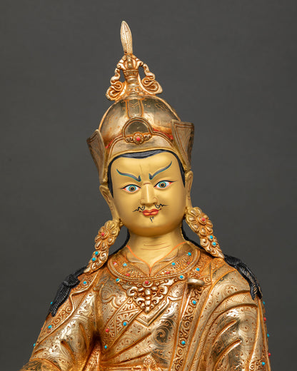 Close up view of Guru Padmasambhava statue showing gold painted face and sacred details