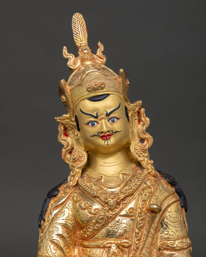 Close-up view of Guru Rinpoche face showing gold-painted expression and intricate hand-carved details with spiritual elegance.