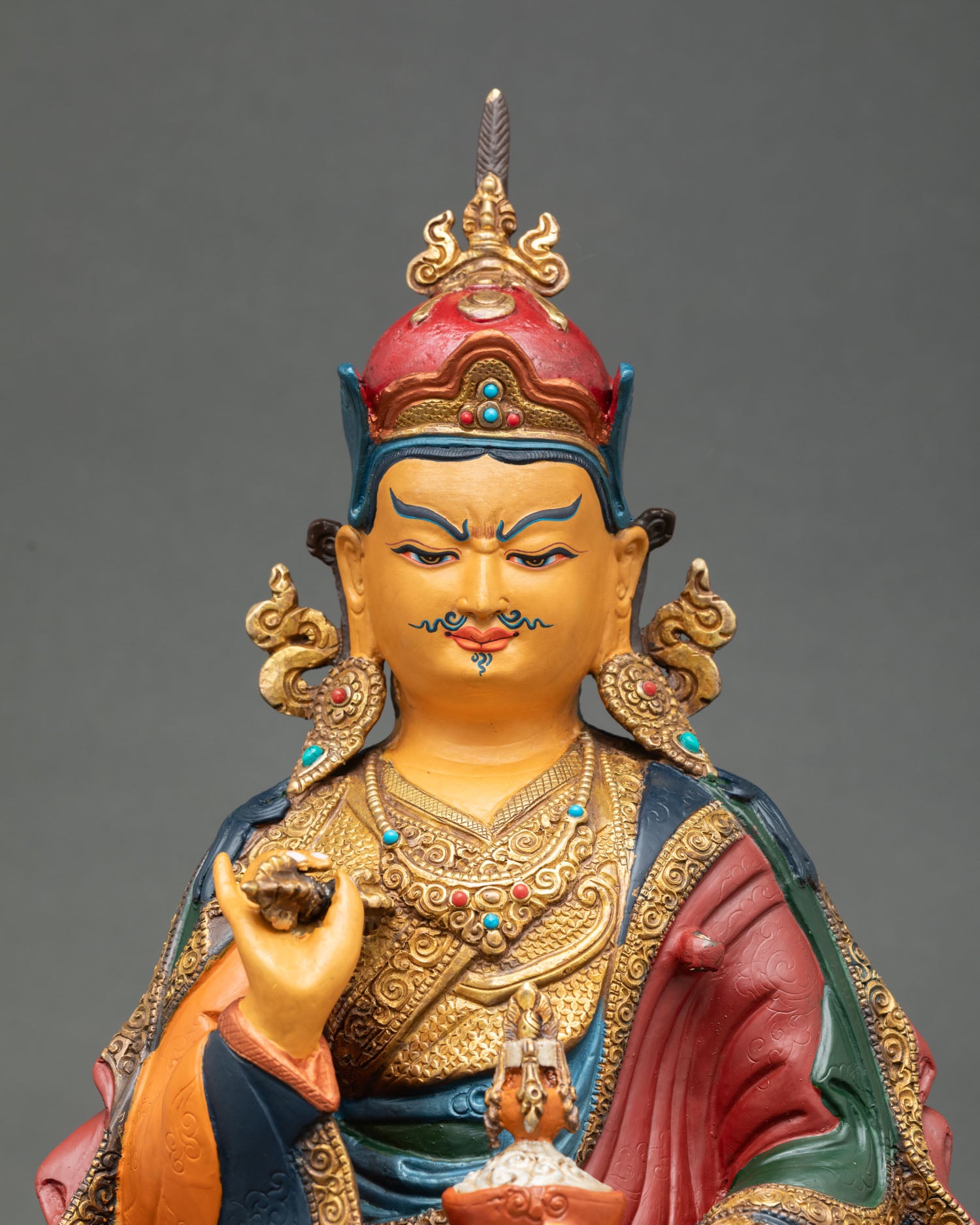 Close up view of Guru Tsokye Dorje statue, hand painted face, semi precious stones