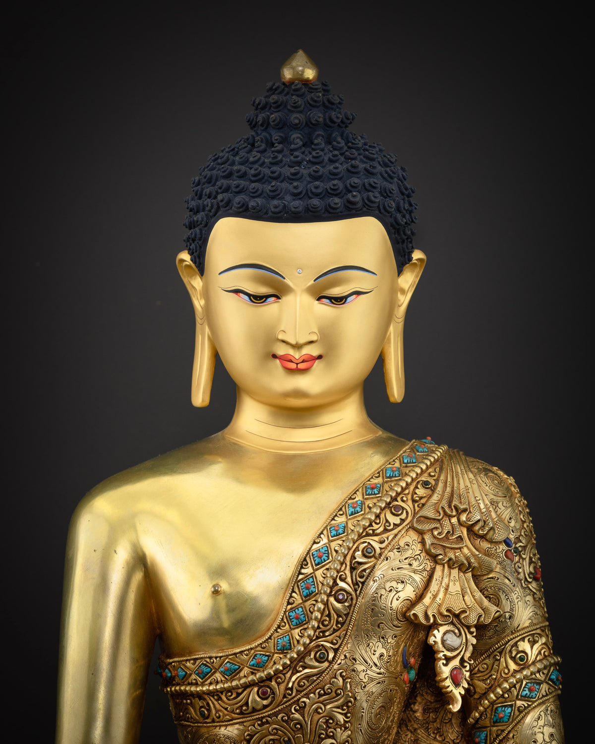 Close-up view of handcrafted copper Shakyamuni Buddha statue showing robe detail