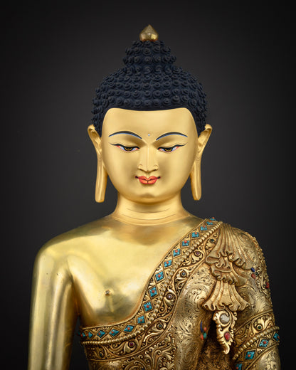 Close-up view of handcrafted copper Shakyamuni Buddha statue showing robe detail