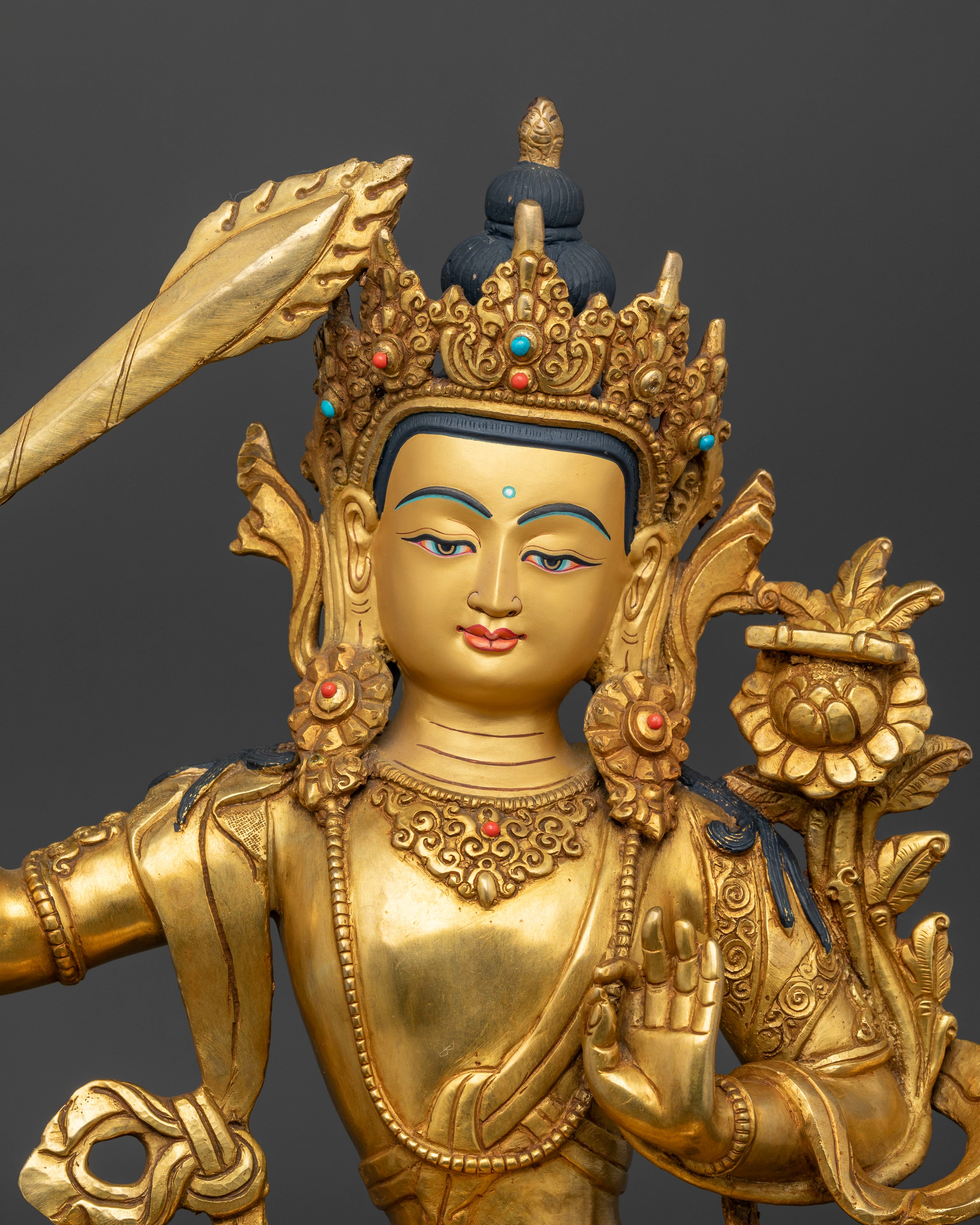 Close up view of Manjushri Statue showing gold details and Nepalese handcrafted artwork