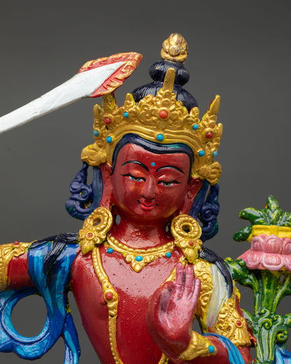 Close up view of Manjushri statue showing serene expression detailed facial features and symbolic wisdom sword and sacred ornaments.