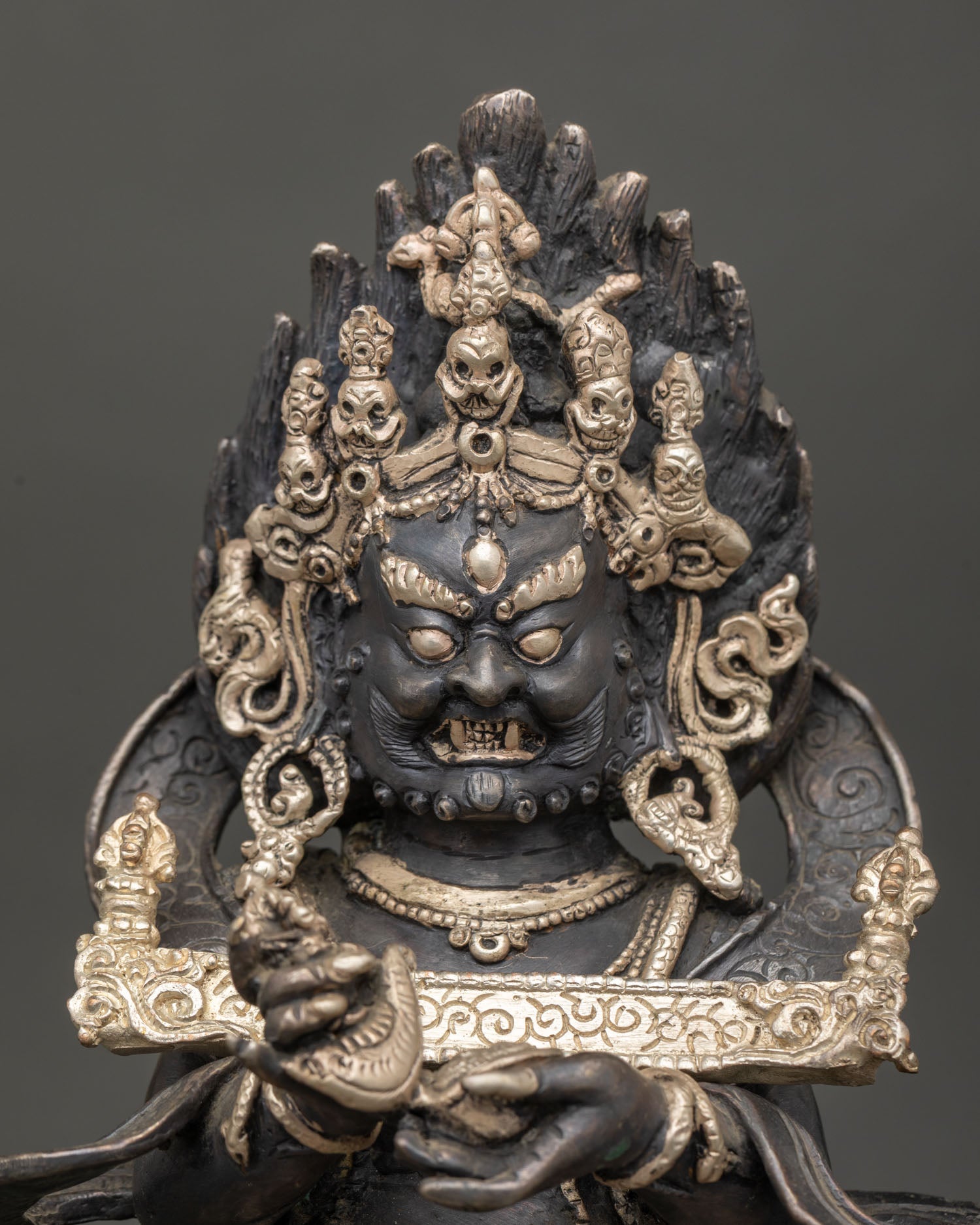 Close up view of Sakya Mahakala face detail, fierce wrathful expression, hand painted acrylic finish on Nepalese ritual sculpture
