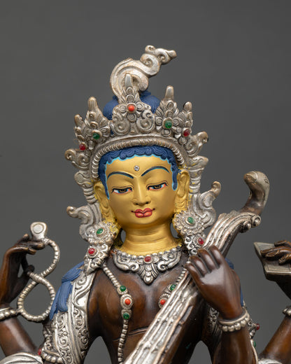 Close up view of Saraswati sculpture showing serene facial expression, detailed halo, semi precious stone ornaments, and intricate Newari craftsmanship