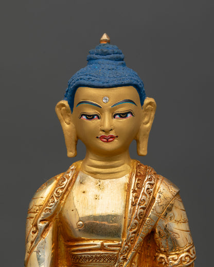 Close up view of Shakyamuni Buddha face 24K gold painted detail serene expression, Himalayan Buddhist art
