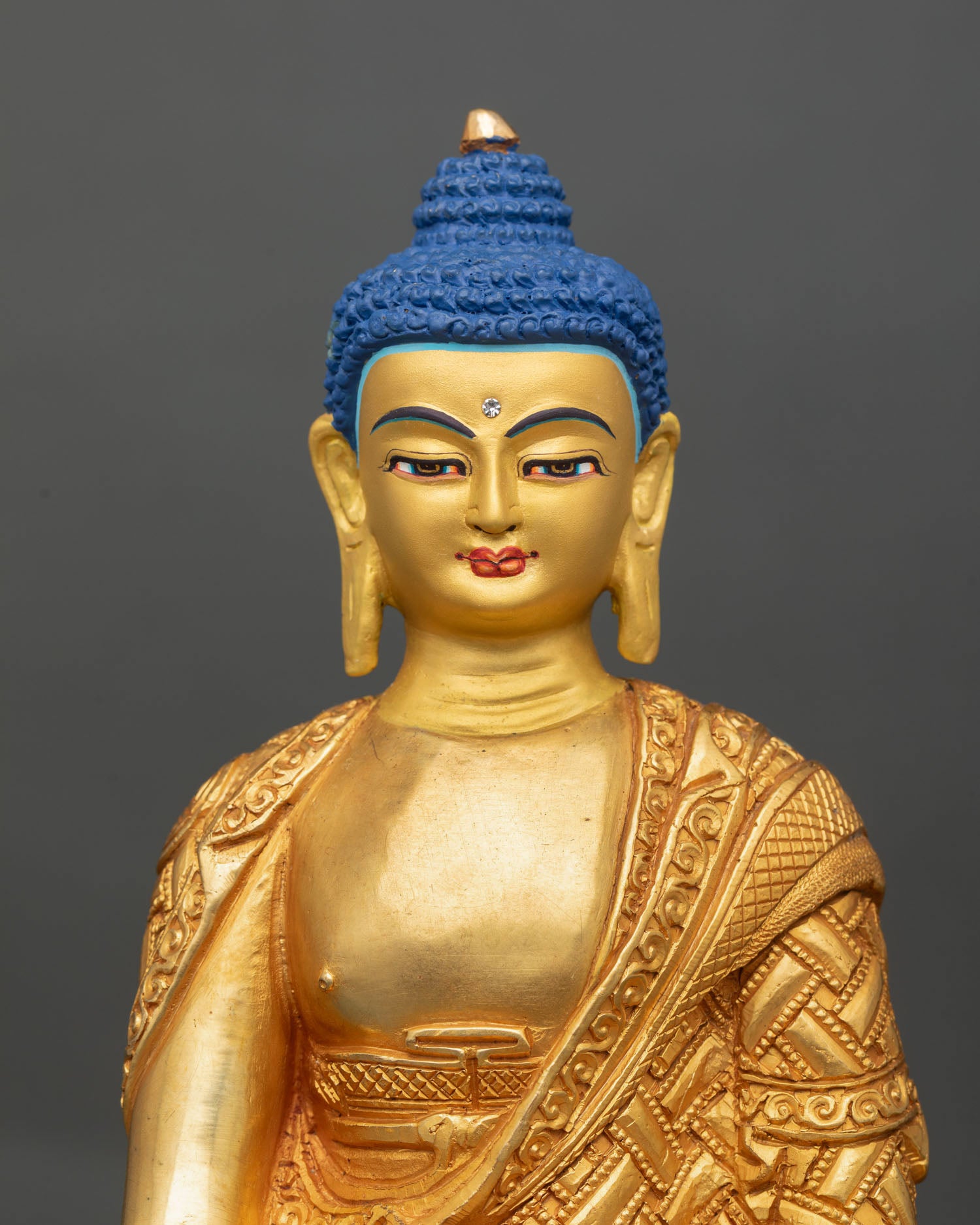 Close-up view of Shakyamuni Buddha's face, gold-painted, serene expression, enlightened wisdom, Himalayan Buddhist art