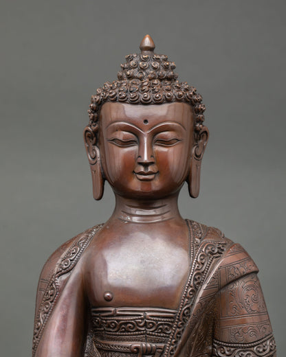 Close-up view of Shakyamuni Buddha sculpture showing a serene face, detailed monastic robes
