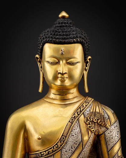 Close-up view of Shakyamuni Buddha serene gold-painted face with detailed craftsmanship and sacred Vajrayana Buddhist art expression