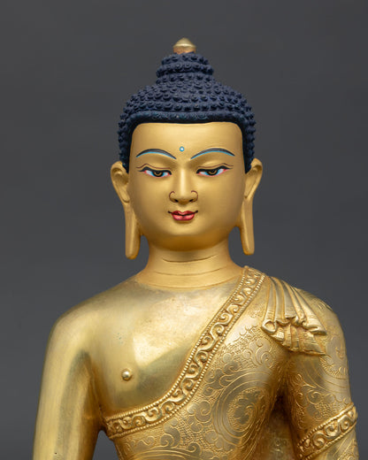 Close-up view of Shakyamuni Buddha statue showing serene gold-painted face with calm expression and enlightened wisdom.