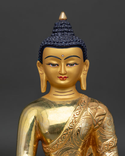 Close up view of Shakyamuni Buddha Statue with serene gold painted face and floral robe carvings