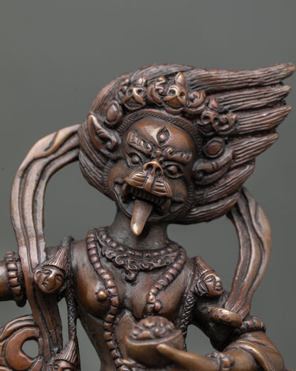 Close up view of Simha Mukha Dakini sculpture highlighting expressive lion face detailed ornaments and ritual Buddhist attributes