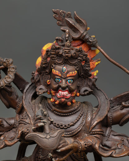 Close up view of Six-Armed Mahakala face with three eyes, gold painted crown and flaming hair detail, Himalayan Buddhist wrathful protector statue by Nepalese artisan.