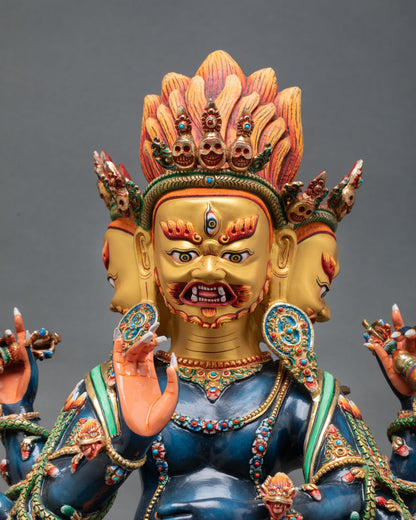 Close up view of Ucchusma sculpture showing fierce three faces, detailed facial expression, Himalayan craftsmanship