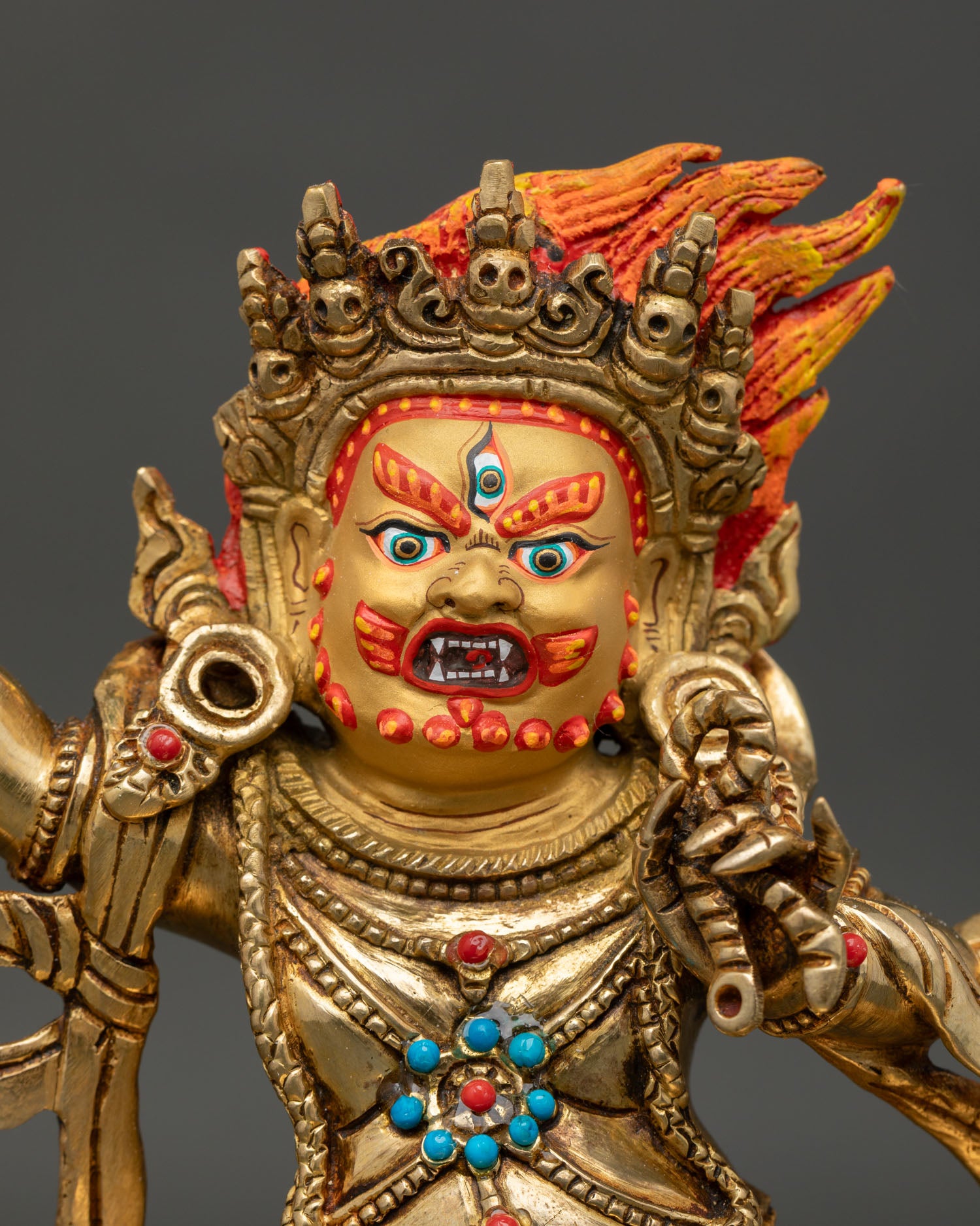 Close up view of Vajrapani Buddhist deity showing wrathful expression vajra lasso and intricate ornaments