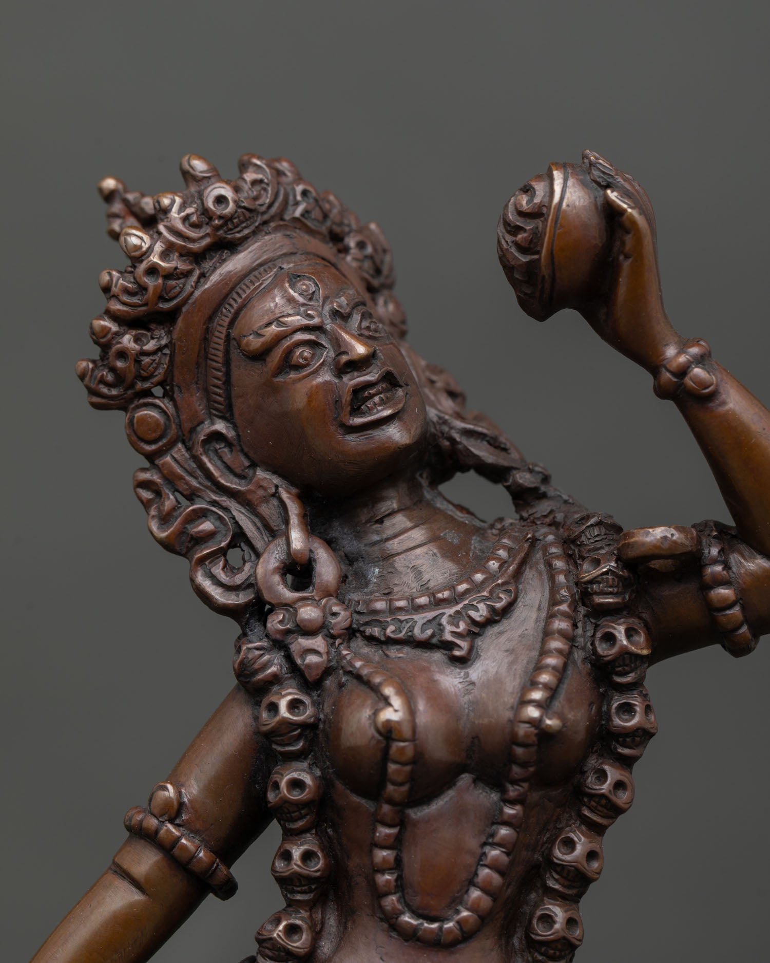Close up view of Vajrayogini face with halo, premium copper Buddhist goddess statue from Patan Nepal.