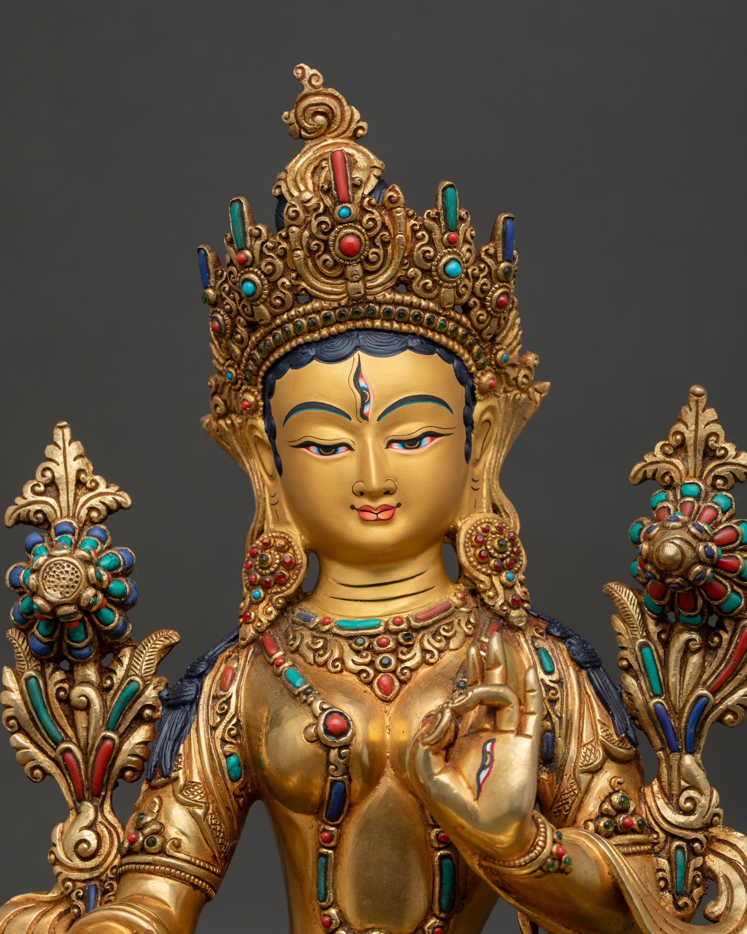 close up view of white tara bodhisattva statue with intricate nepalese craftsmanship