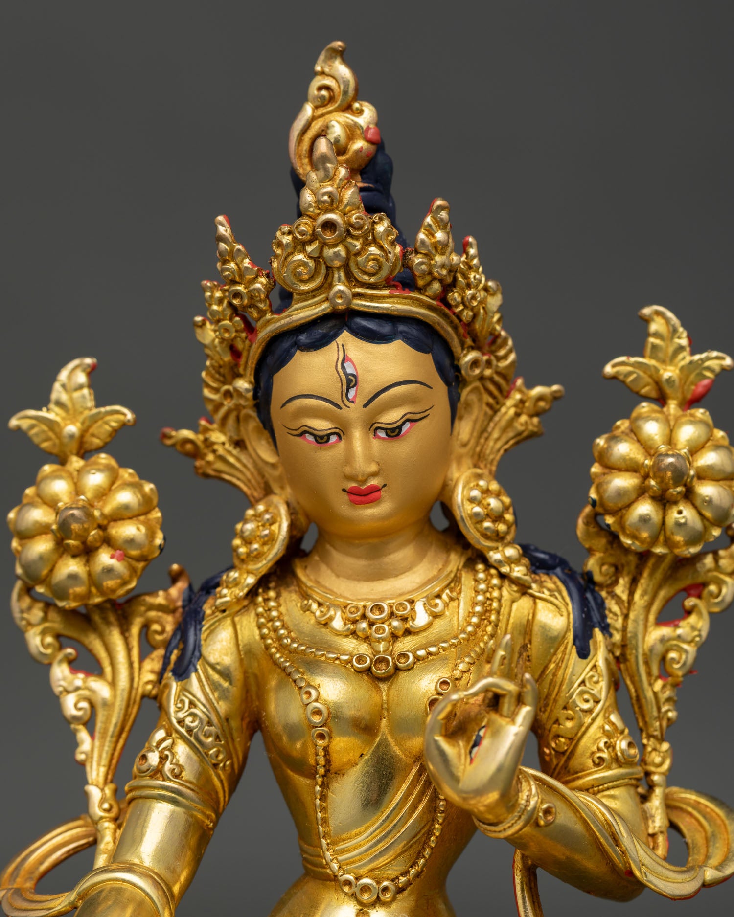 Close up view of White Tara Buddhist goddess statue, showing compassionate facial details