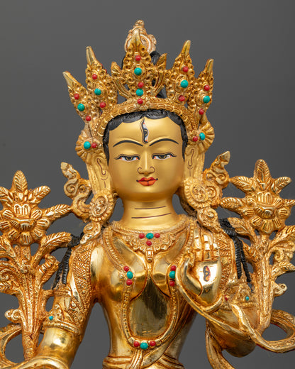 Close up view of White Tara with gold painted face and semi precious stone details