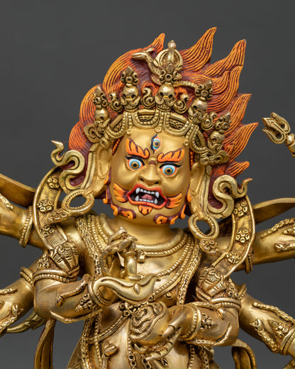 Close-up view of wrathful Mahakala with three eyes, flaming hair, and a gold-painted face symbolizing fierce Dharma protection