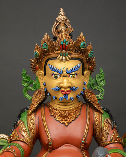 close up view of yellow dzambhala statue showing intricate gold details and sacred ornaments