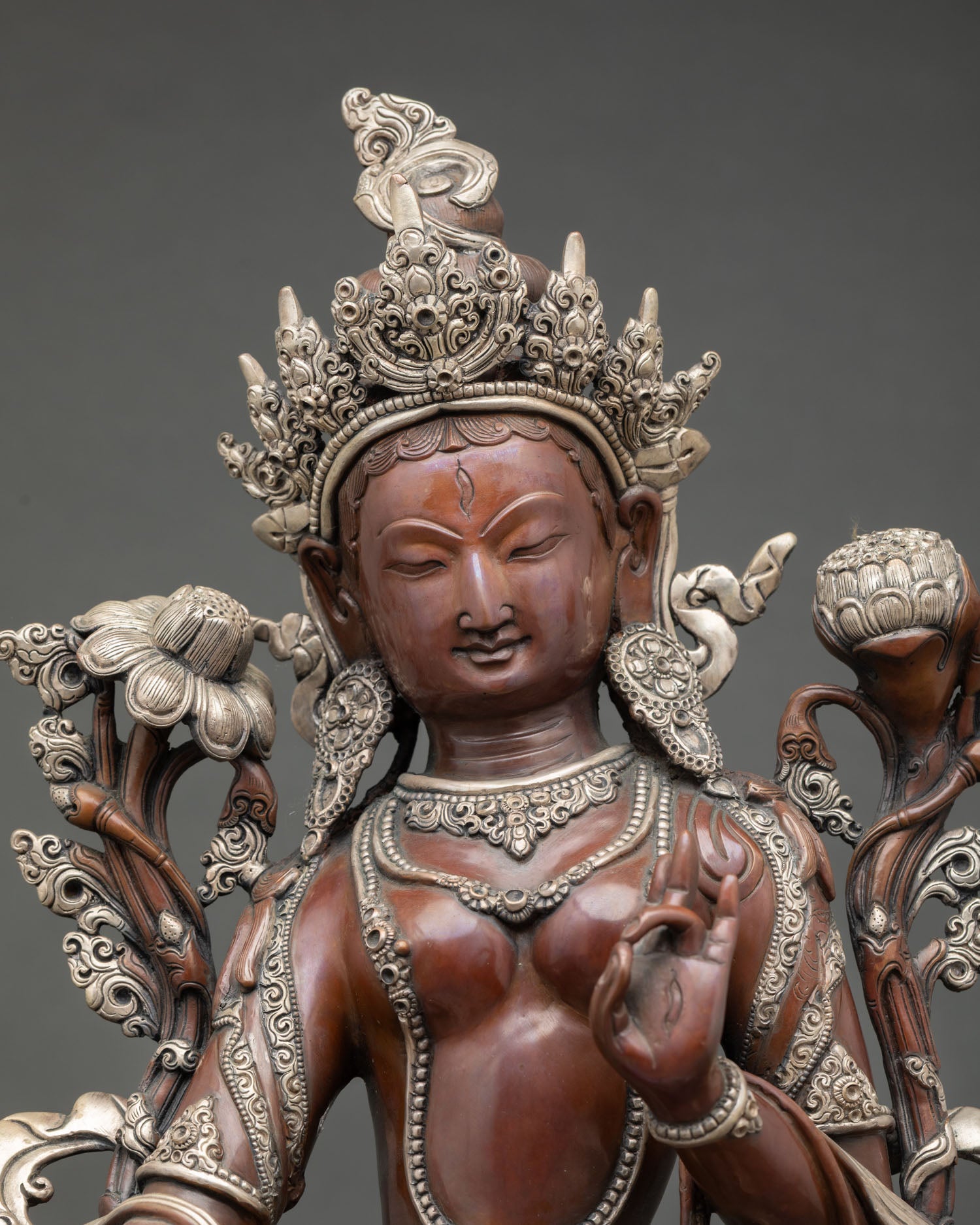 Close up view White Tara face with seven all seeing eyes symbolizing compassion healing wisdom and longevity in Himalayan Buddhist sculpture