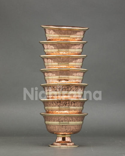 Close-up water offering bowl, copper, handcrafted Tibetan ritual set