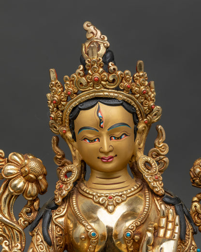 Close-up of White Tara statue showing intricate crown, jewelry, and lotus details