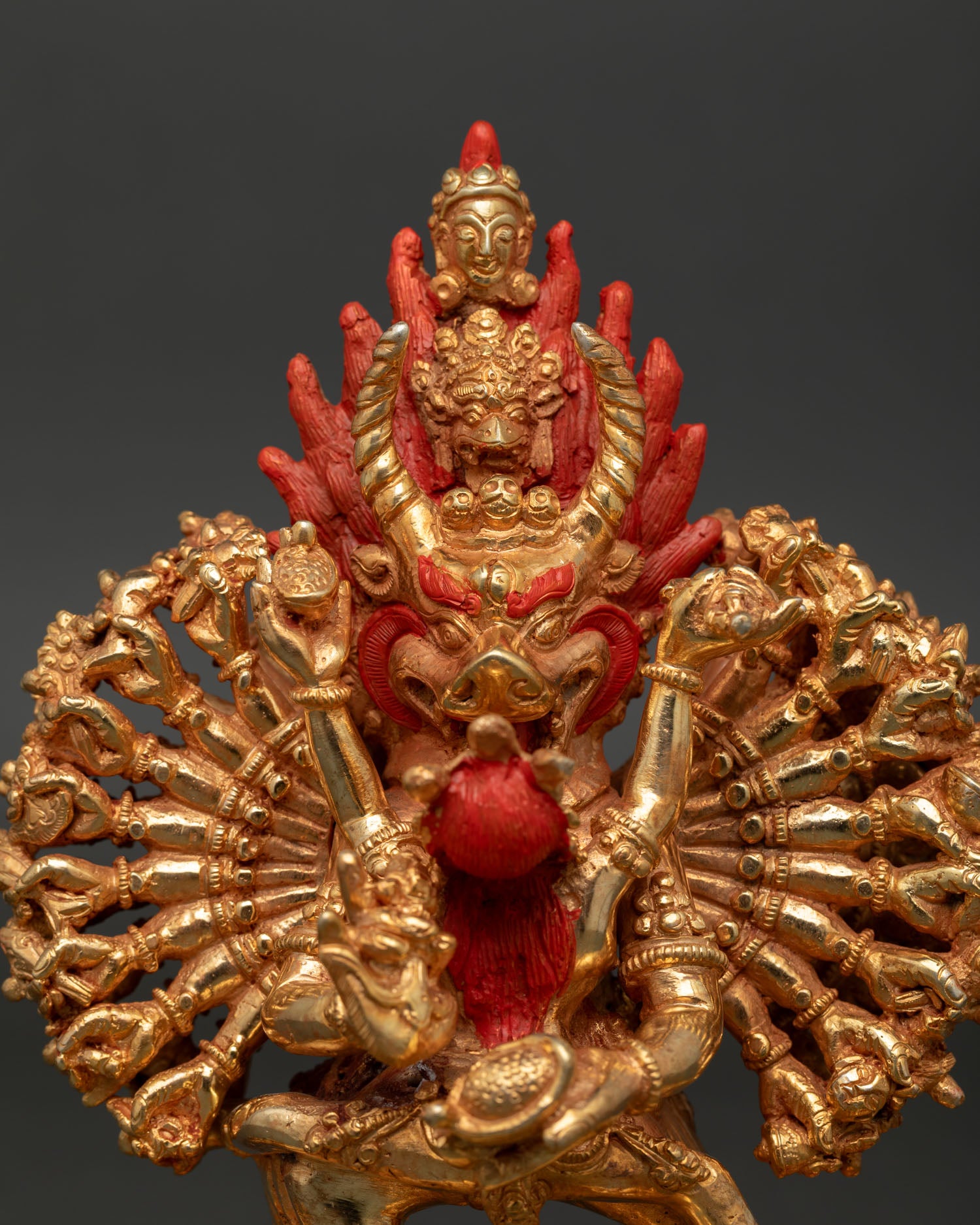Close up Yamantaka face detail gold painted expression flaming wisdom halo vajrayana buddhist sculpture