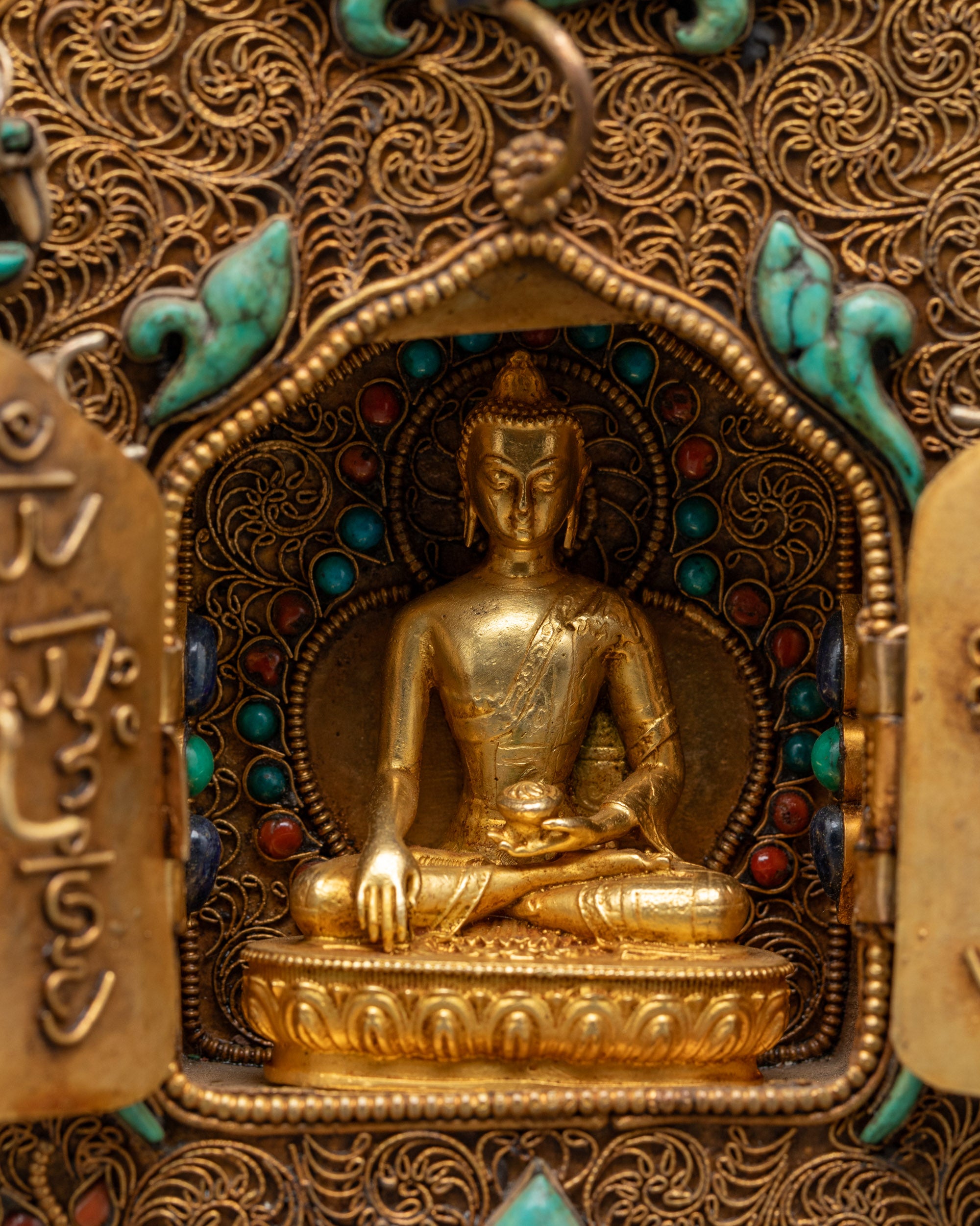close-up Buddha Shakyamuni Ghau Box showing 24k gold-plated figure in bhumisparsa mudra
