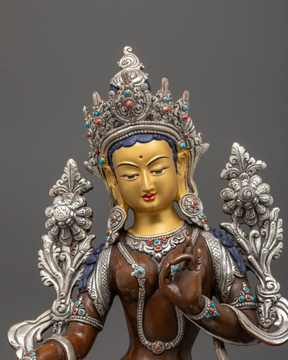 close-up of Green Tara’s face, crown, and blooming utpala flower with silver-plated details