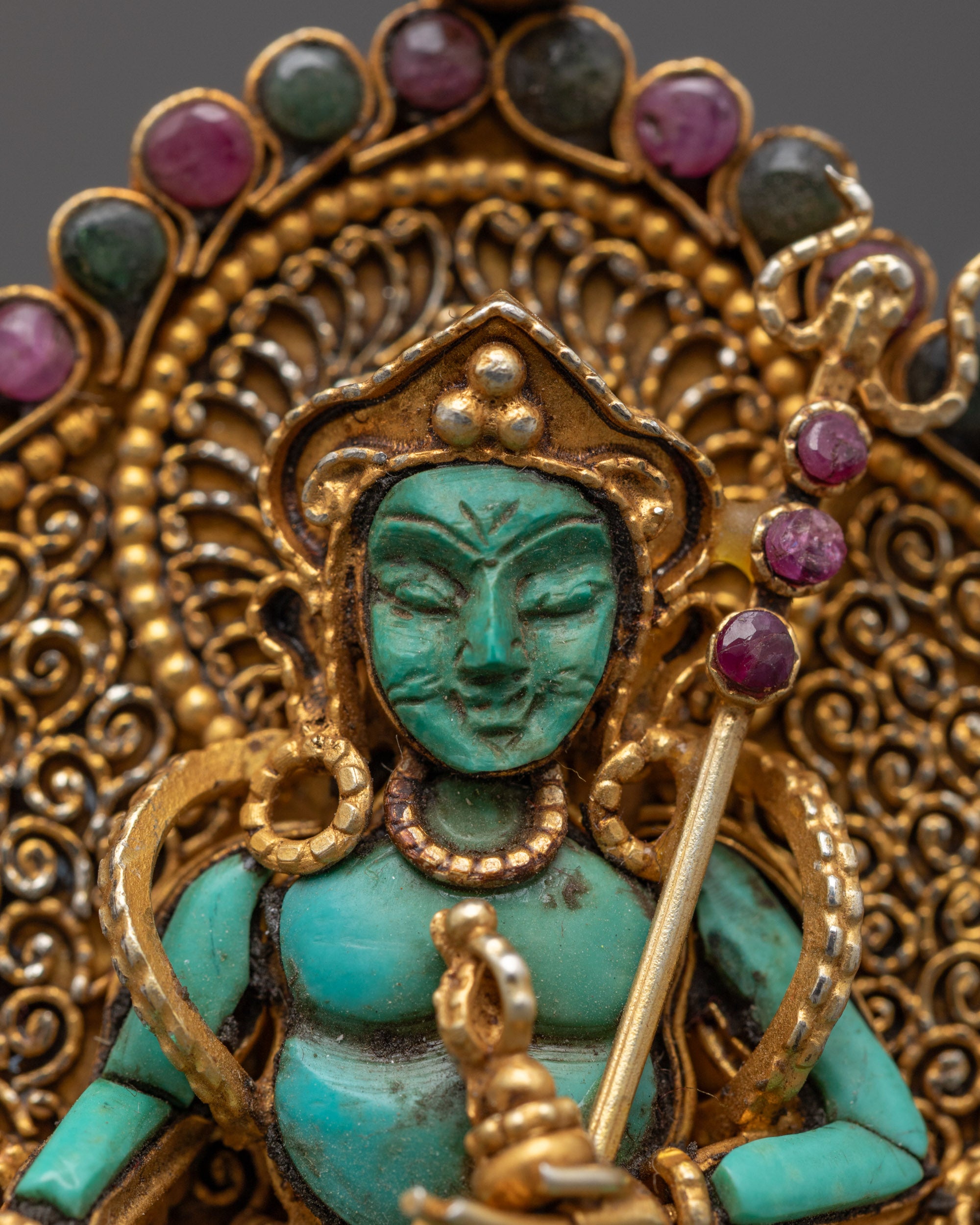 close-up of Guru Rinpoche locket showing vajra, kapala vase, and turquoise centerpiece