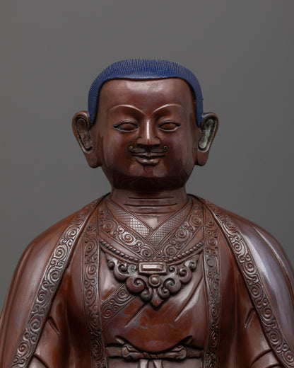 close-up of Marpha Statue face highlighting calm expression and oxidized copper texture