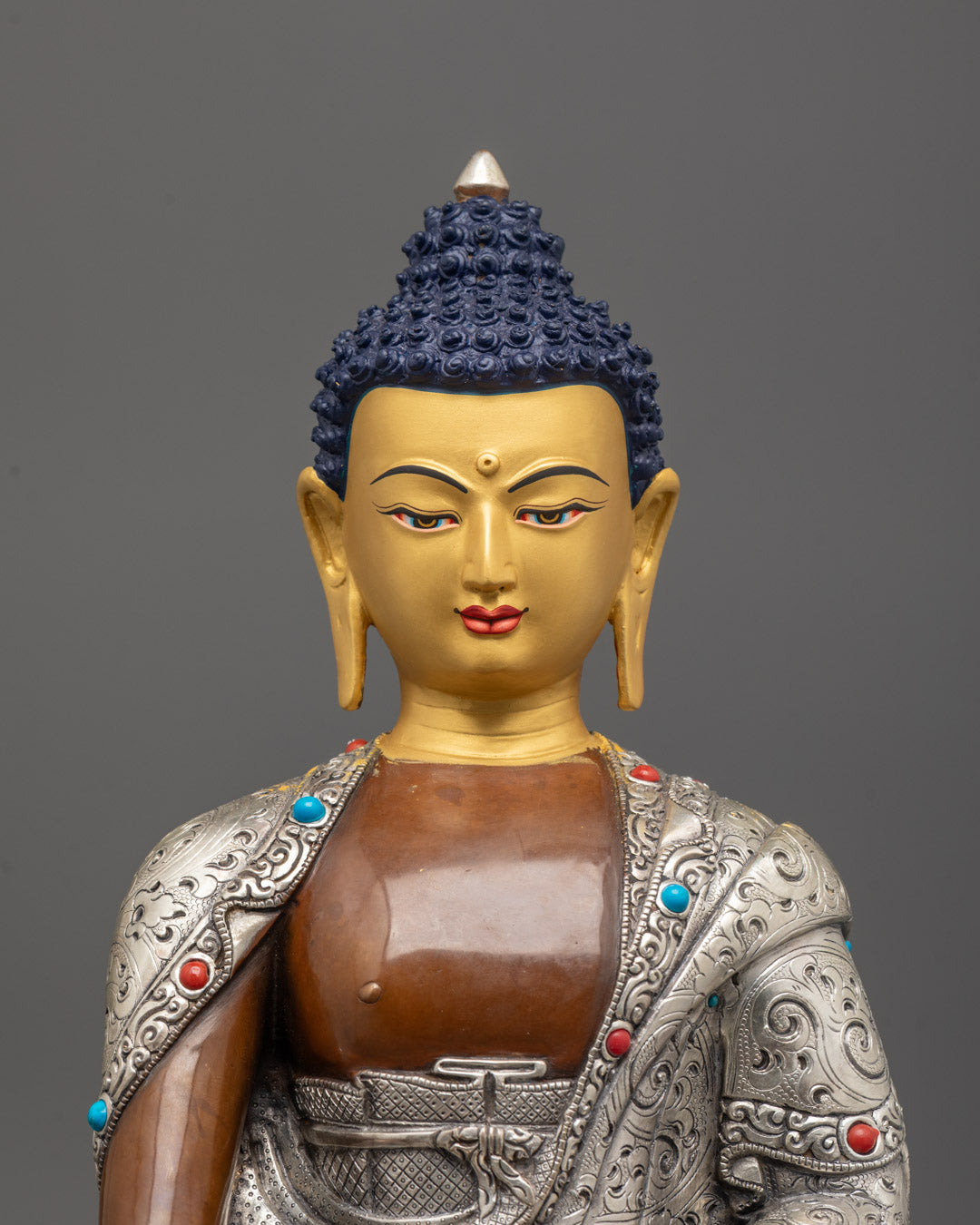 close-up of Shakyamuni Buddha’s silver-plated robe, patra bowl, and gemstone details
