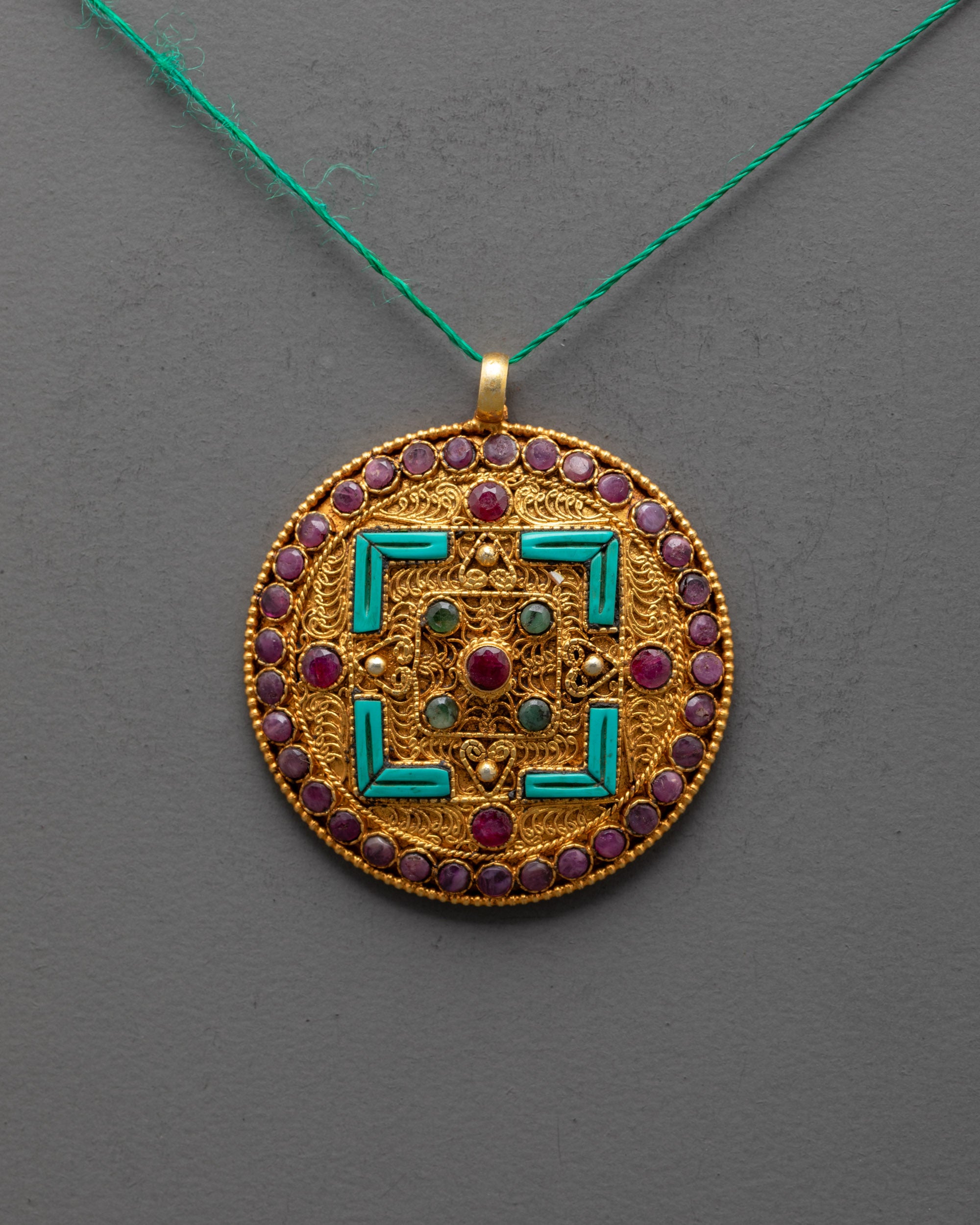 close-up of mandala locket showing semi-precious stones and premium carved details