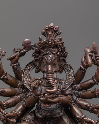 close-up of oxidized copper Ganesha face with halo and intricate sacred object details