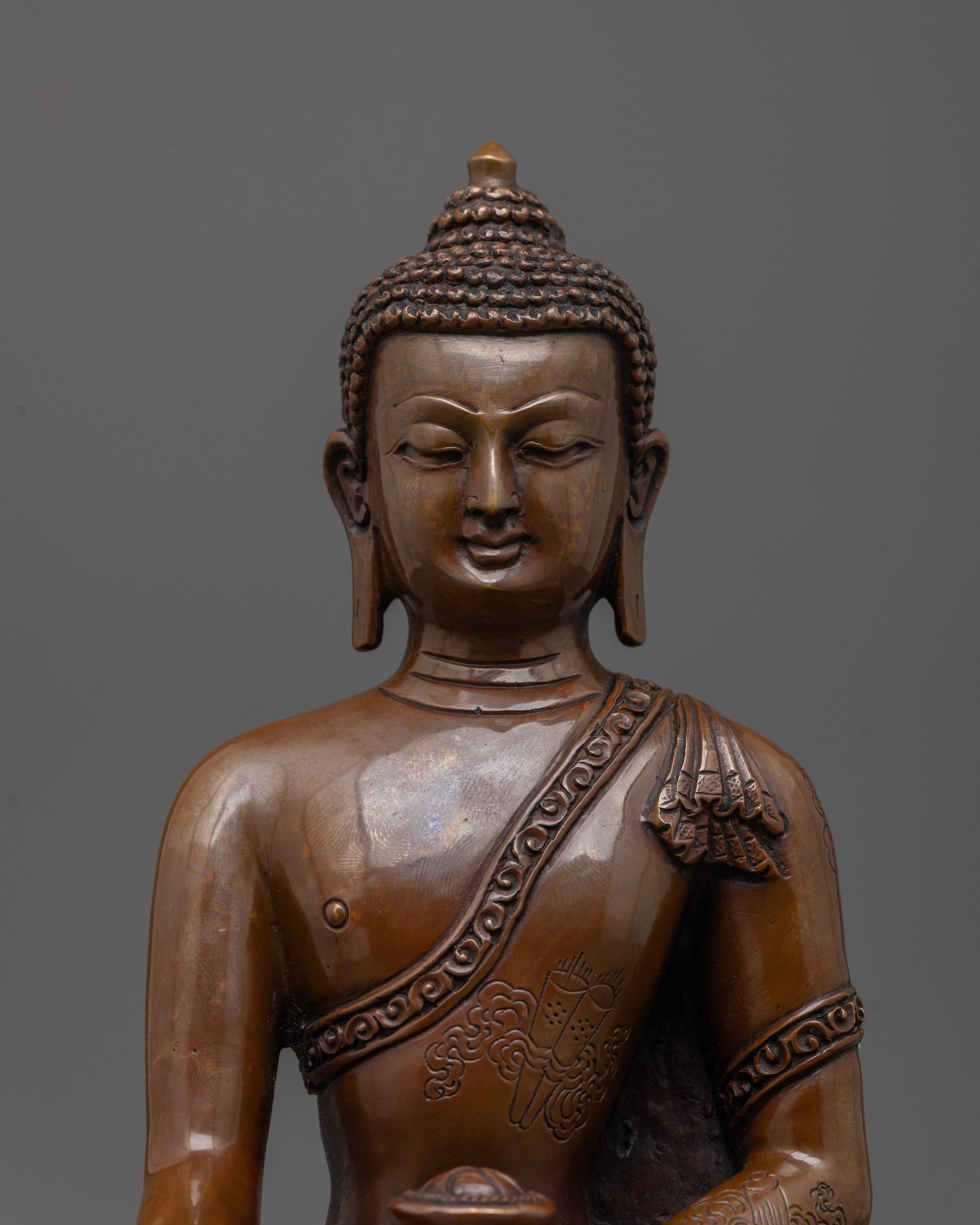 close-up of oxidized copper face of Shakyamuni Buddha showing antique finish and calm expression
