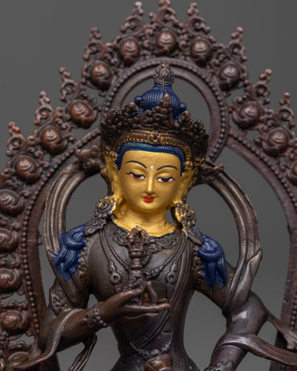 close-up of vajrasattva statue showing jeweled robes and finely detailed lotus seat