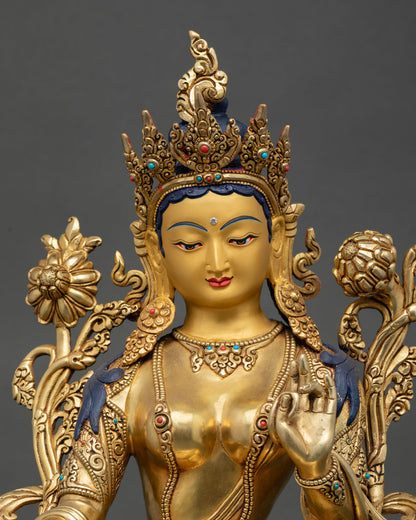Close view of Green Tara face showing 24k gold finish semi precious stones and peaceful expression