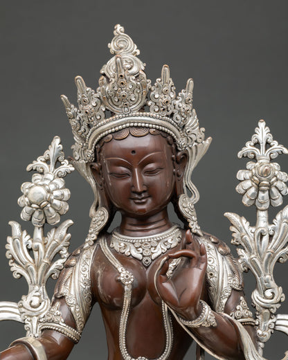 Close view of Green Tara statue showing detailed craftsmanship, oxidized silver plated surface, and serene expression.