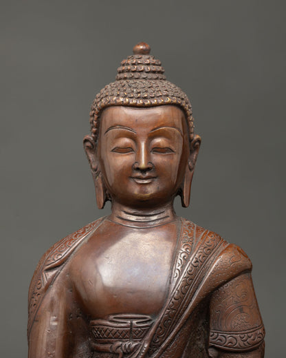 Close view of Shakyamuni Buddha face showing serene expression, intricate Nepalese metalwork, and spiritual Buddhist artistry.