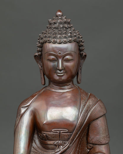 Close view of Shakyamuni Buddha statue showing serene expression, oxidized copper texture, and Nepalese craftsmanship.