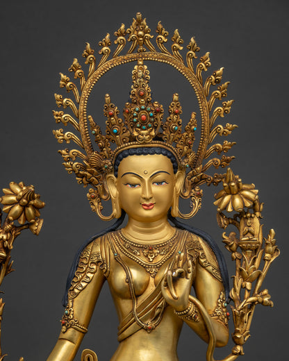 close view of standing green tara statue showing ornate crown and gold gilded details