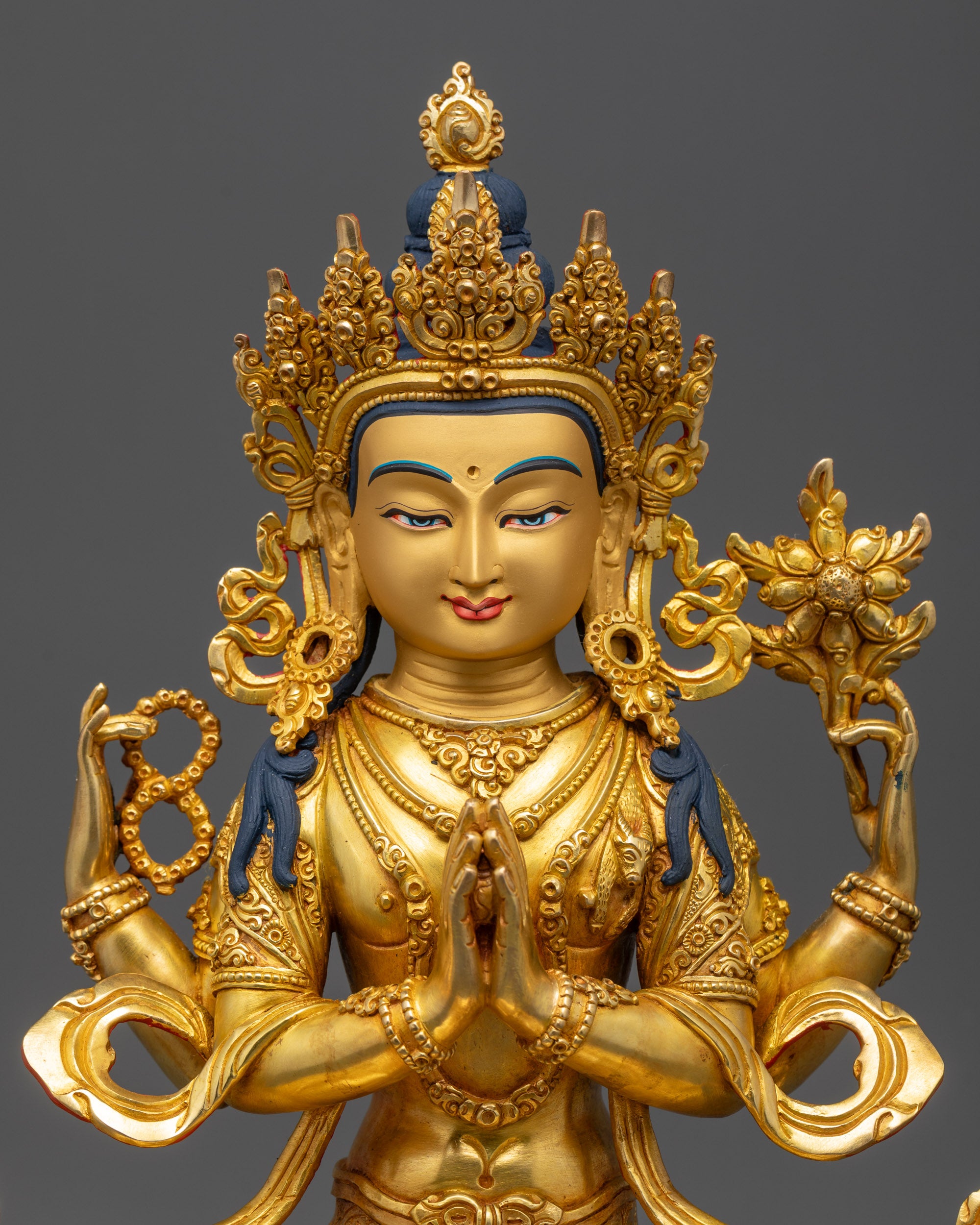 close up Avalokiteshvara face with five-jeweled crown and detailed ornaments gold gilded
