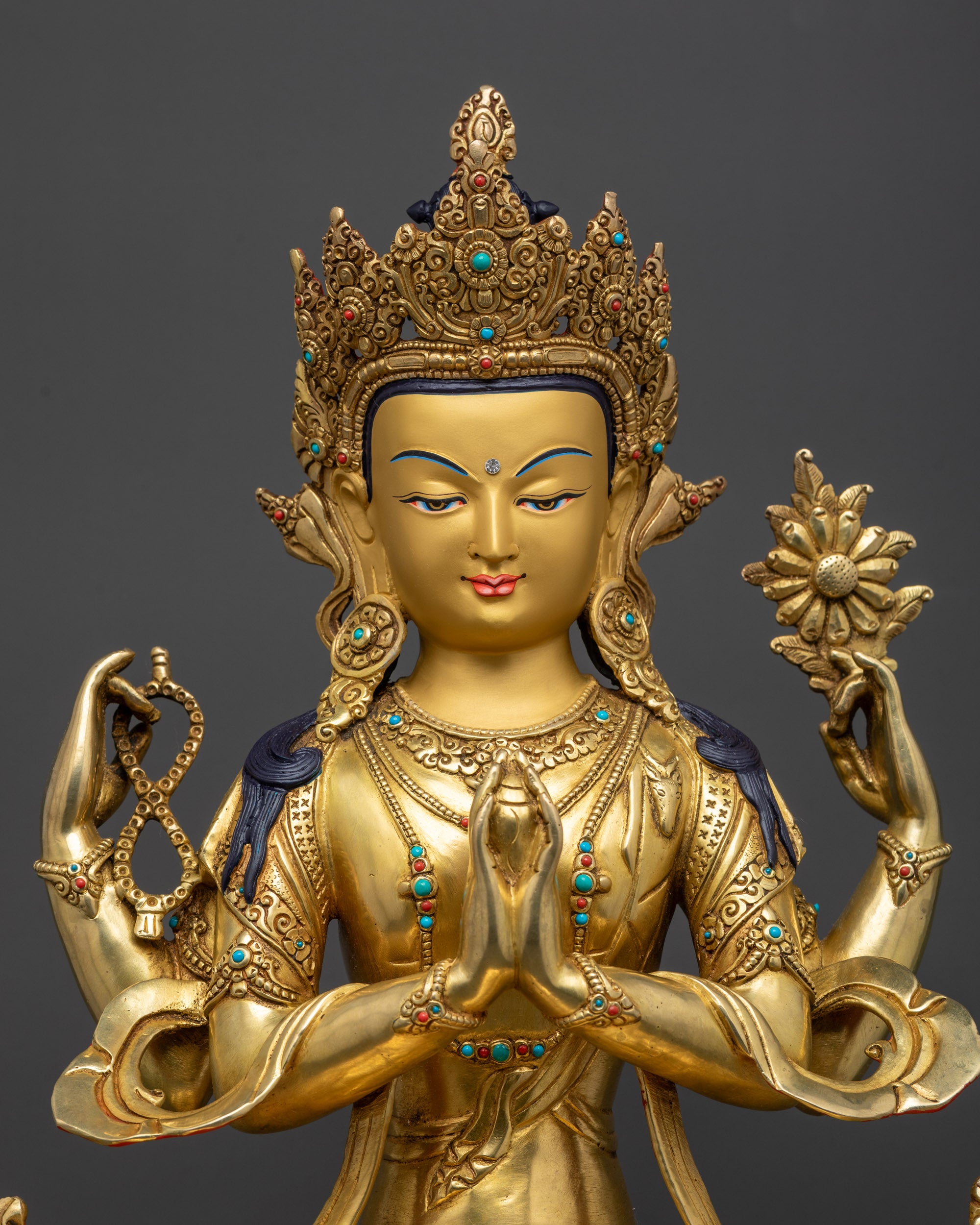 close up Chenrezig statue crown, armlets, and swirling robe details handcrafted in Nepal
