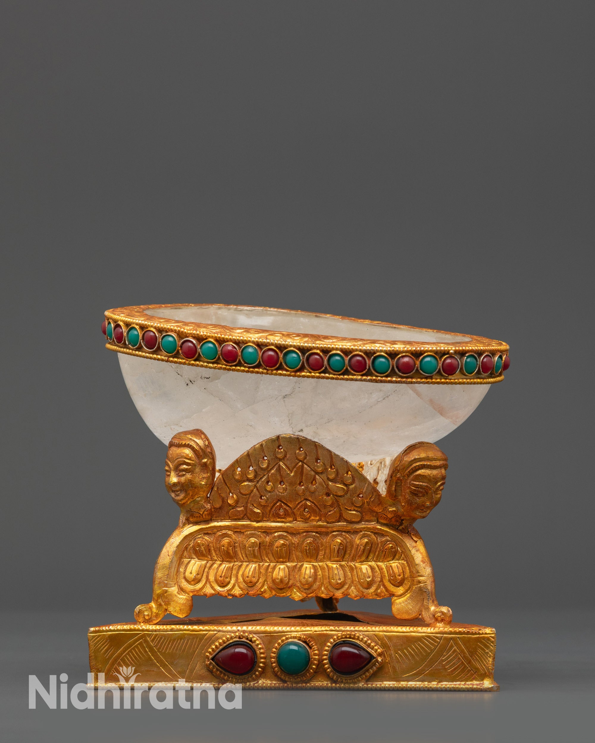 close up Crystal Skull Cup adorned with carved deities and semi-precious stones detail
