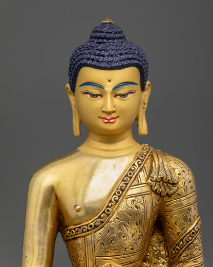 close up Golden Shakyamuni Buddha face showing Bhumisparsha Mudra and alms bowl detail