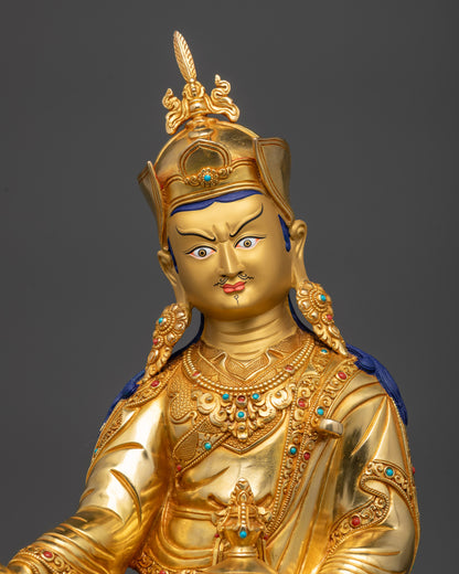 close up Guru Padmasambhava statue with semi-precious stones and carved patterns
